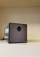 Front view showing tinted LED display panel and projection lens