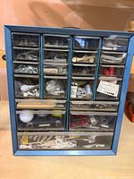 Front view of 20-drawer cabinet filled with assorted items