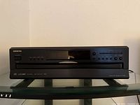 Front view of Onkyo DX-C390 CD changer showing brand, display, tray and controls