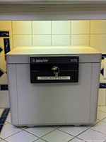 Front view of Sentry 1170 fire safe showing lock panel and key