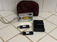 Camera rear view, charger, flash drives, pouch
