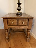 Full view of Ethan Allen end table showing drawer, legs, stretcher