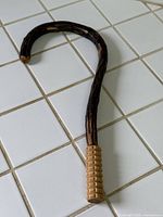 Full view of curved wooden back massager with ribbed handle