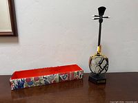 Shamisen on stand beside patterned storage tray