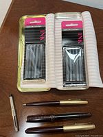 Overview of three Parker pens, loose converter, two sealed ink cartridge packs