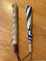 Both umbrellas side by side closed in sleeves