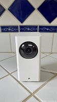 Wyze indoor security camera front view on tiled surface