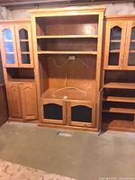 Front view of entire oak entertainment center showing three modular sections