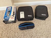 Lot overview showing boxed Wahl GroomsMan Pro, two Wahl zip cases, small zip pouch