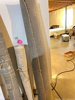 Rolled beige/tan carpet standing upright