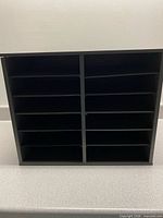 Front view showing 12 compartments and black finish