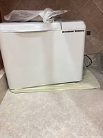 Full left side view of white Breadman Ultimate bread maker on countertop