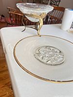 Compote on stand and charger showing overall design and gold rims