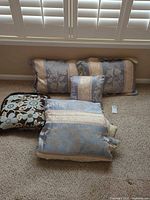 Three decorative pillows showing patterns and colors