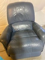 Front view of dark blue faux leather recliner showing padded seat, back, and arms