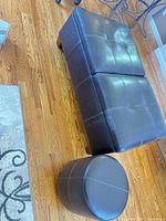 Rectangular dark brown faux leather ottoman bench with matching round ottoman