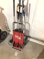 Full view of push cart with bag and clubs