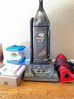 Hoover upright vacuum, Dirt Devil handheld vacuum, hose, vacuum bags, tubs and box