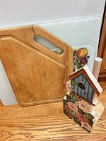 Wood and plastic cutting boards plus paper towel holder
