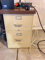 Front view of beige 2-drawer filing cabinet with wood top