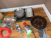 Overview of bakeware and utensils on floor