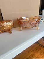 Both carnival glass bowls side by side displaying size difference