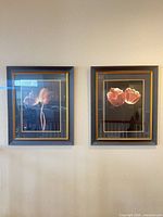 Both framed tulip artworks mounted on wall