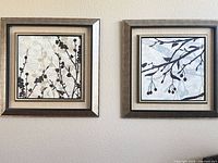 pair of framed prints hung side by side