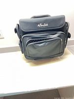 Front view of black The Paper Studio rolling craft tote