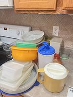 Group view of pitchers, mixing bowls, colander, round server, produce saver