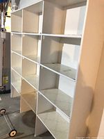 Front view of white 16-cubby shelf unit