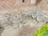 Group of 11 wine glasses upside down on countertop