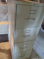 Full front view of beige 4-drawer filing cabinet