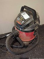 Overall view of King Canada 5 gal 3.5 HP wet-dry shop vacuum with hose attached