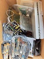 Box containing I⁄O cards, power board, software manuals, cables, slim external drive