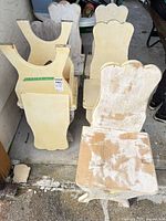 Group of painted wooden chairs showing yellow and distressed white finishes and wear