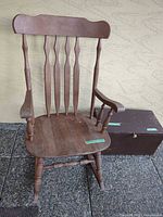 Rocking chair beside storage chest showing overall condition