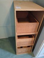 Tall narrow cabinet full view with drawers visible