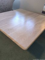 Top view of square travertine coffee table showing surface finish and rounded corners
