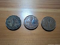 Three 1943 Canadian Tombac 5-cent coins reverse side showing Victory torch, date and denomination