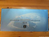Blue outer presentation box with globe graphic and Millennium Canada 2000 text