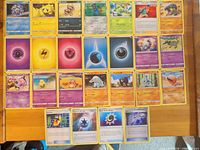 First set of cards laid out showing Pikachu, Energy cards and assorted Pokémon