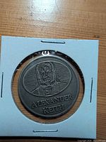 Obverse portrait side of Alexander Keith token in 2x2 holder