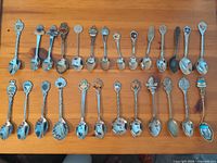 Full lot overview of 26 souvenir spoons