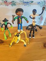 Group shot of all five rubber figures on table