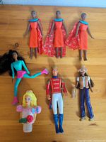 All seven dolls laid out on table