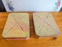 Top view of two sandwich tins showing bread graphic