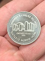Token obverse showing Ontario Place design and bilingual text