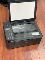 Printer open showing flatbed scanner glass and lid