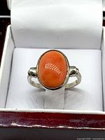 Front view showing bezel-set oval coral cabochon and sterling band
